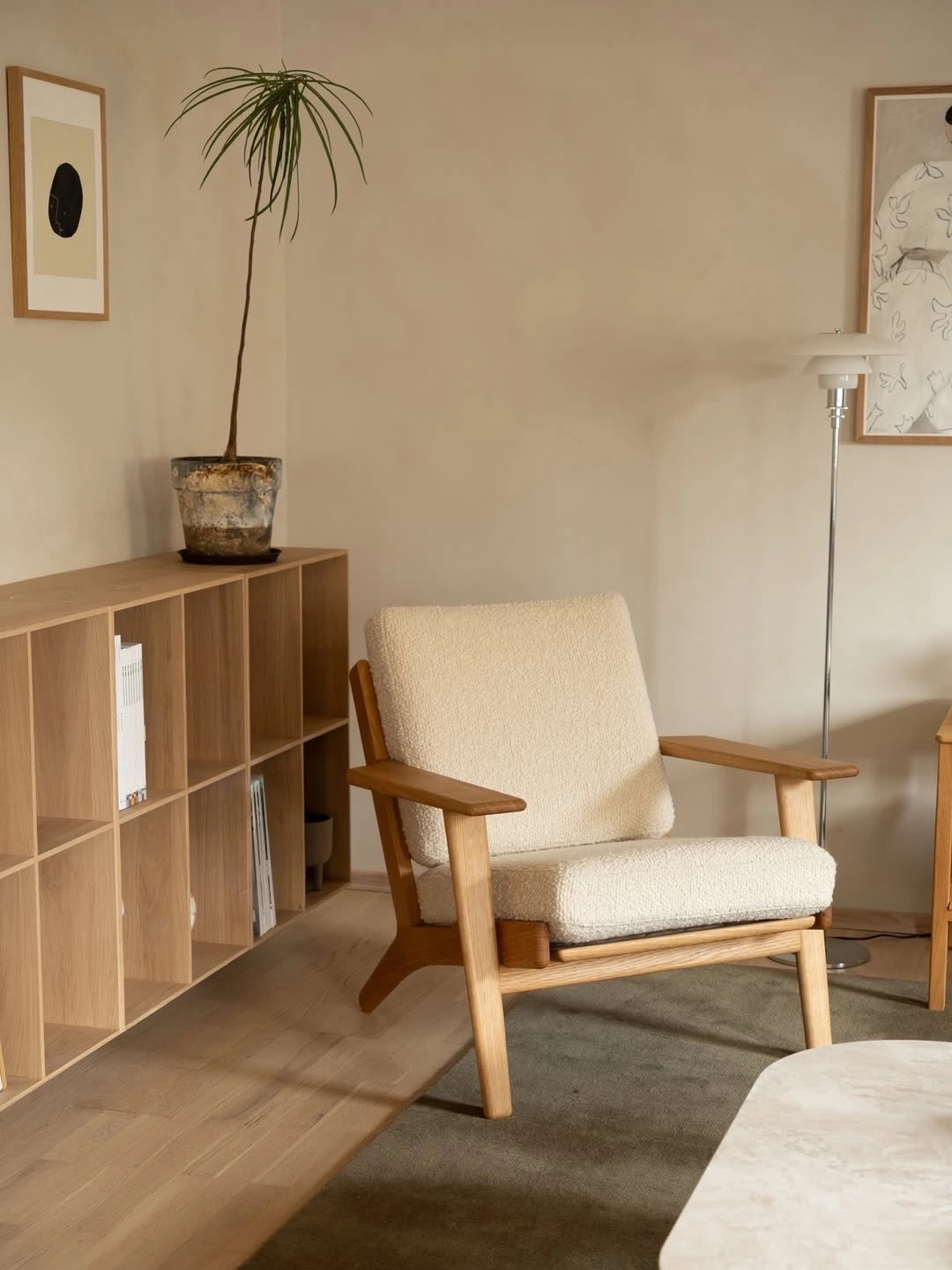 A quiet corner of the therapy room, with an oak armchair and soft lamplight